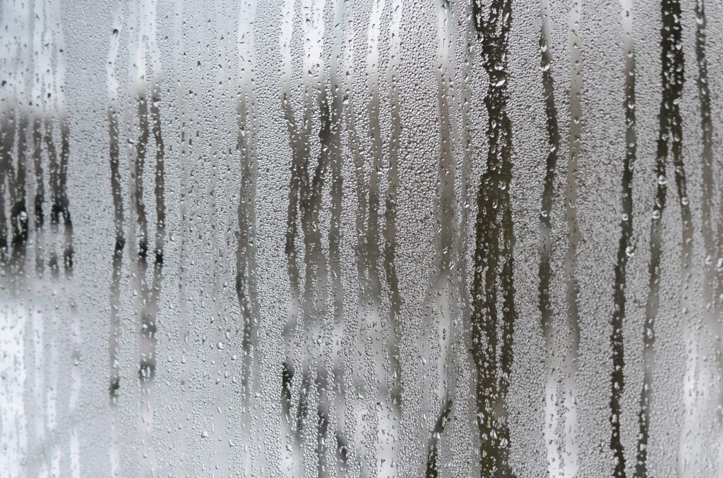 The texture of a misted glass with a lot of drops and condensation flows. Background image