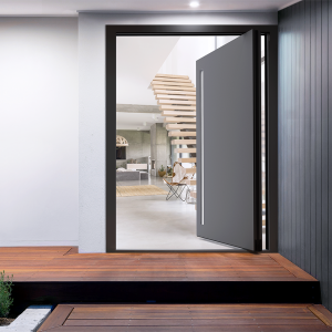 A modern [cortizo Millenium Plus pivot door] with a wooden floor and stairs.