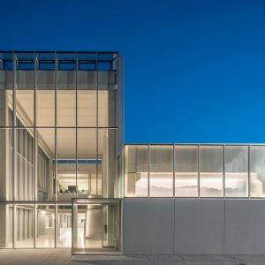A white building with a glass facade of Curtain Walling: ECW-50 Curtain system at night.